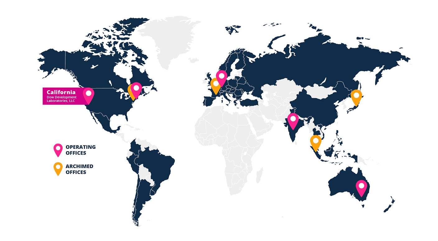 World map highlighting global office locations. Pink map pins indicate operating offices in California, eastern United States, United Kingdom, central Europe, India, and Australia. Orange map pins indicate archived offices in western Europe, Japan, and Southeast Asia. A callout label identifies California as Dow Development Laboratories, LLC, and a legend distinguishes operating offices from archived offices.